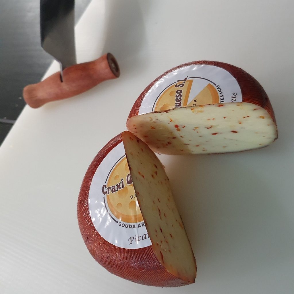 Haz tu propia salsa de queso picante con queso Gouda artesanal con chiles. Queso de granja holandés Gouda con especias elaborado con leche cruda de vaca