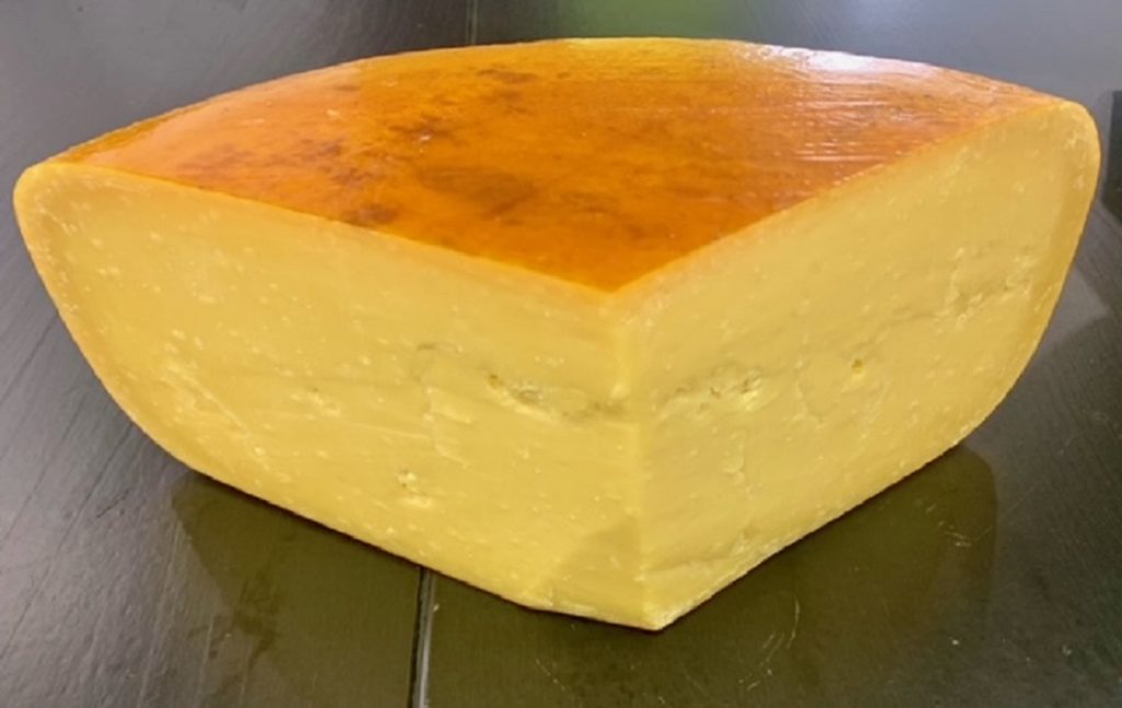 Assortment of artisan gourmet cheese: natural, spiced, and smoked, perfect for cheese lovers