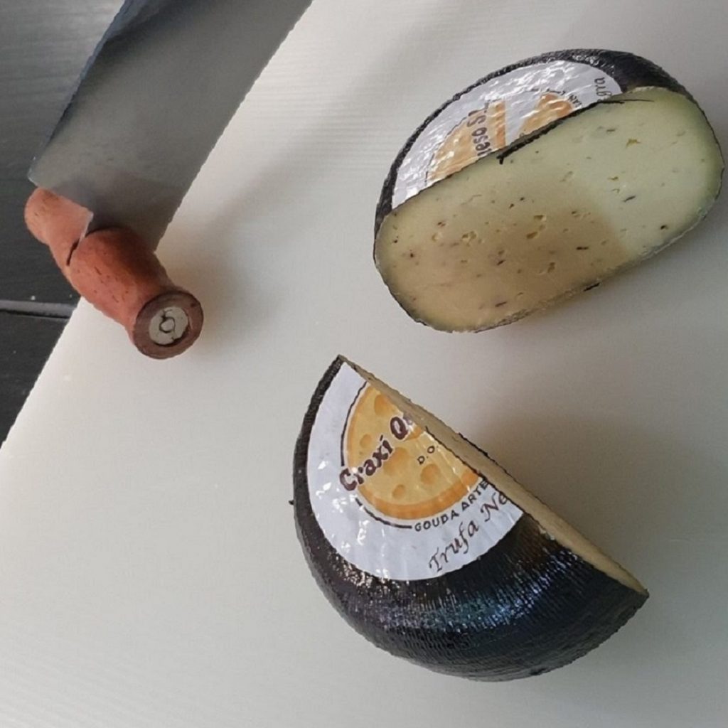 Mini cheeses with truffle. Artisanal Craxi Gouda cheese with black truffle
